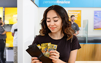 Woman receiving a cash advance in store