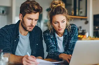 Man and lady looking at laptop