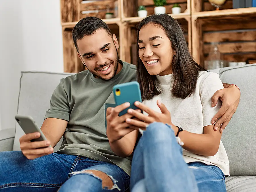 Young couple viewing phones